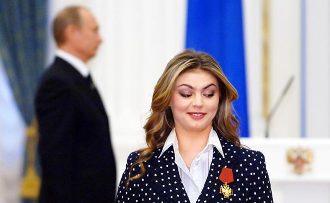 На фото: олимпийская чемпионка по художественной гимнастике Алина Кабаева и президент РФ Владимир Путин ( на втором плане).