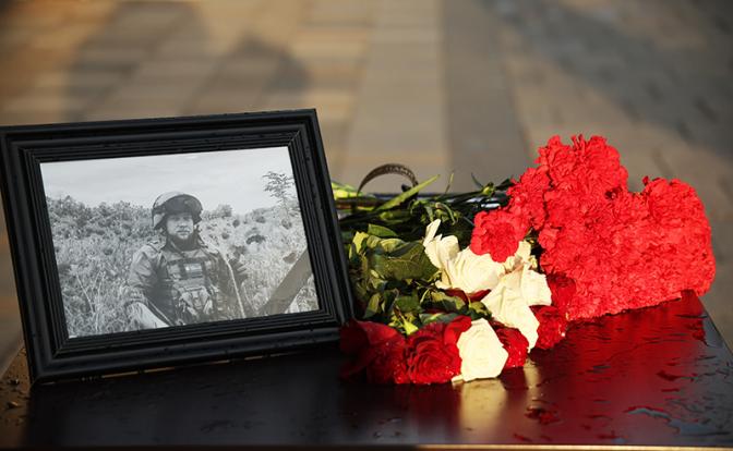 На фото: цветы с фотографией погибшего корреспондента Ростислава Журавлева у здания информационного агентства "Россия сегодня".