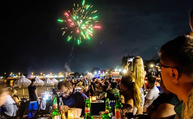 На фото: туристы в кафе на берегу океана в городе Денпасар, остров Бали, Индонезия.