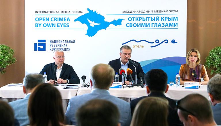 Россия. Алушта. 11 июня 2017 года. Председатель совета директоров Национальной резервной корпорации (НРК) Александр Лебедев, глава Республики Крым Сергей Аксенов и официальный представитель МИД России Мария Захарова (слева направо на дальнем плане) во время медиафорума "Открытый Крым: своими глазами"